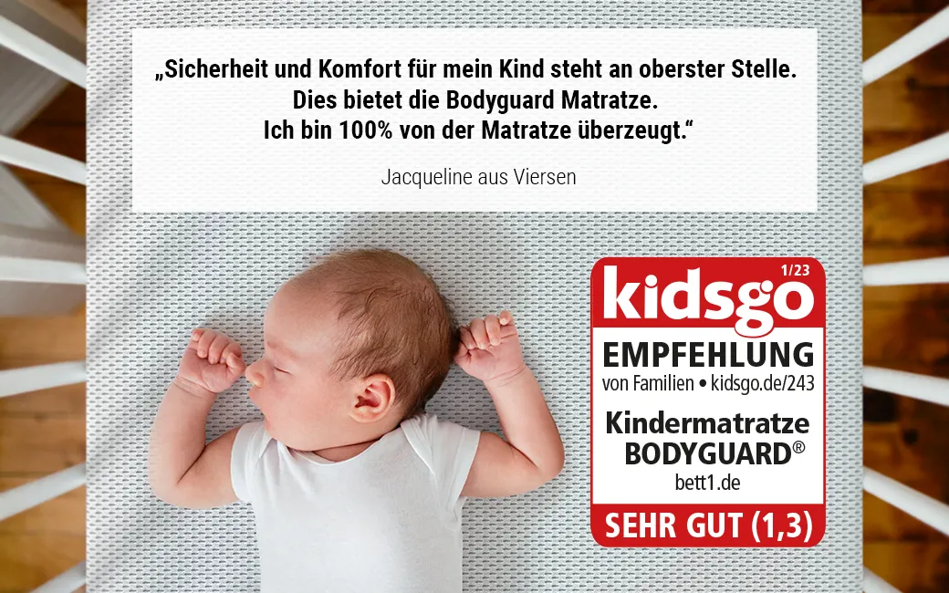 Baby in Gitterbett. Text: „Sicherheit und Komfort für mein Kind steht an oberster Stelle. Dies bietet die Bodyguard Matratze. Ich bin 100% von der Matratze überzeugt.“ Jacqueline aus Viersen