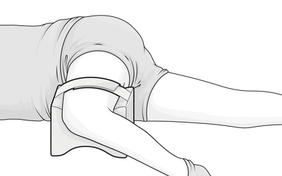 Illustration: Eine Person in Seitenlage hat ein Bein angewinkelt auf dem Kniekissen abgelegt und das andere flach daneben ausgestreckt.	